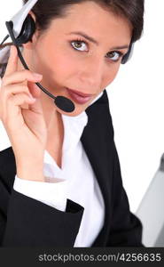 Smart young woman wearing a telephone headset