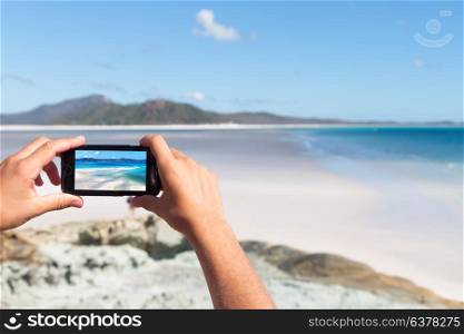 smartphone in australia the beach of Whitsunday Island like paradise concept and relax