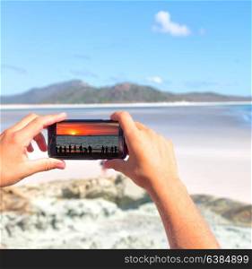 smartphone in australia the beach of Whitsunday Island like paradise concept and relax