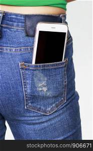 smartphone in the old jeans pocket on wood background