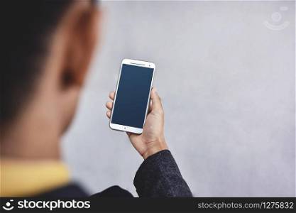 Smartphone Mockup Image. Display Screen is Clipping Path. Modern Businesman Using Mobile Phone. Rear View