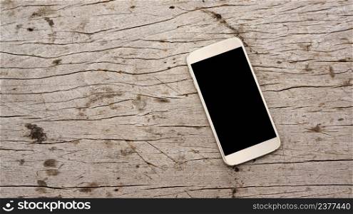 Smartphone on a wooden background.