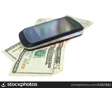 smartphone over heap of dollar on white