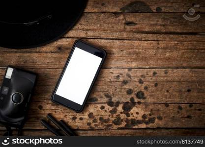 Smartphone white screen on wooden table.Top view  . Smartphone white screen on wooden table.  