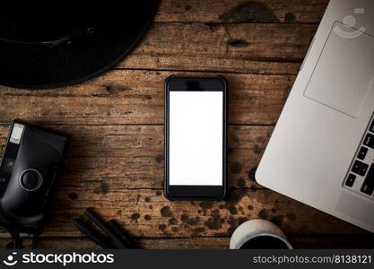 Smartphone white screen on wooden table.Top view  . Smartphone white screen on wooden table.  