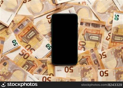 smartphone with blank display mockup screen on 50 euro banknotes. Modern technology, communication and online trade using gadget concept.Money paper. Concept of business, investment and income growth. smartphone with blank display mockup screen on 50 euro banknotes. Modern technology, communication and online trade using gadget concept. Money paper. Concept of business, investment and income growth