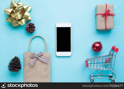 Smartphone with Christmas decorations. Christmas mock up template for online shopping concept. View from above