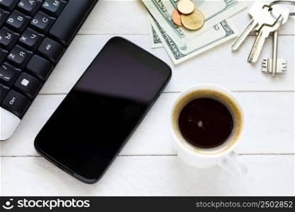 Smartphone with coffee on wooden table