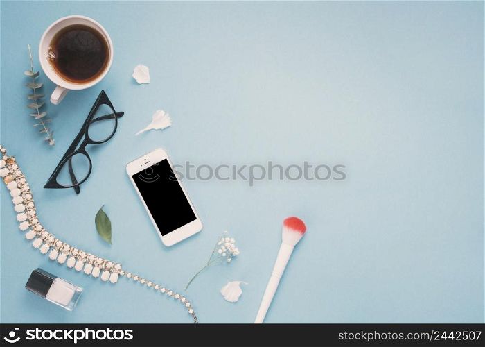 smartphone with glasses tea cup flowers