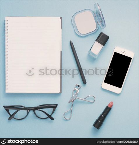 smartphone with notebook cosmetics blue table