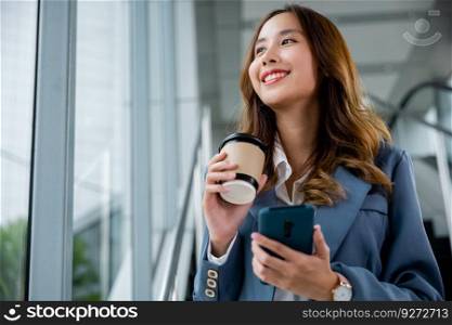 Smartwatch and smartphone in hand, female person looking at the clock. Modern office or workspace background. Ideal for business and technology-related themes.