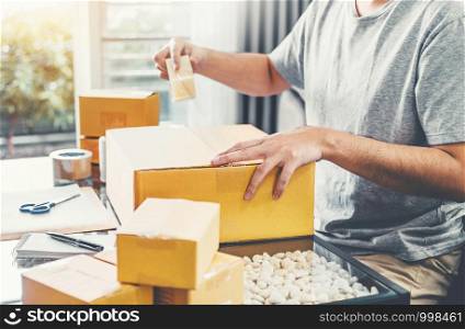 SME freelance man working with packaging startup entrepreneur small business owner at home,Online business seller packaging and delivery concept