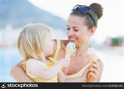 Smeared mother and baby eating ice cream