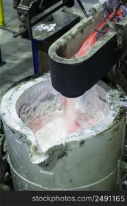 smelting of aluminum metal in the ladle closeup. factory shop for metal smelting
