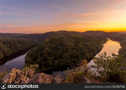 Smetana viewpoint high on rocks above Vltava river in summer sunset, Czech Republic