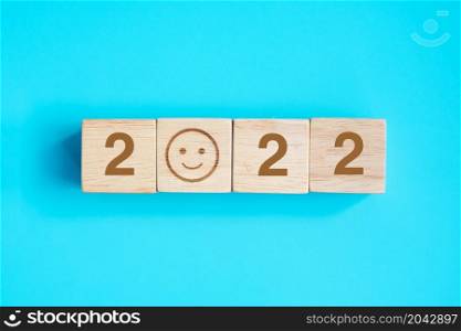 Smile face block with 2022 text on blue background. Satisfaction, feedback, Review and New Year concepts