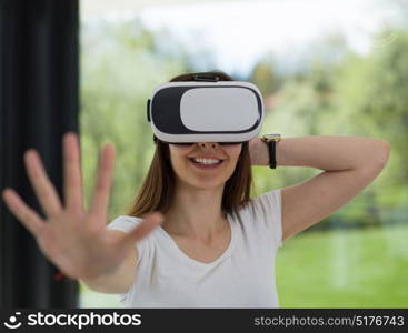 Smile happy woman getting experience using VR-headset glasses of virtual reality at home