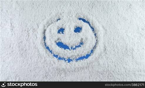 Smile symbol drawn on snow background with matte