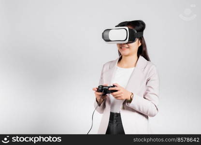 Smile woman confidence excited wear 3D VR headset device and playing game virtual reality experience with joystick isolated white background, Asian happy female play video game studio shot,copy space