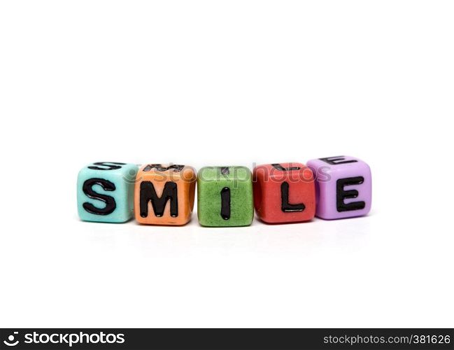 smile - word made from multicolored child toy cubes with letters