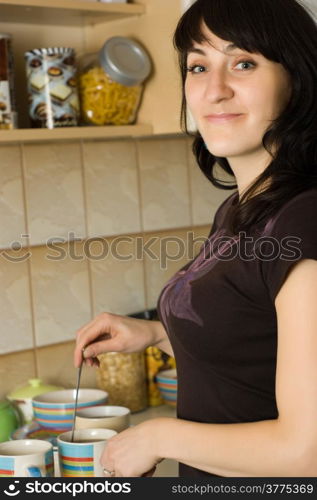 Smile young beautiful woman in kitchen - portrait,