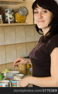 Smile young beautiful woman in kitchen - portrait,