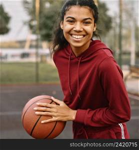 smiley black american woman holding basketball