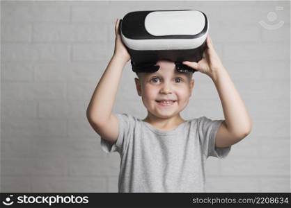 smiley boy playing with vr headset