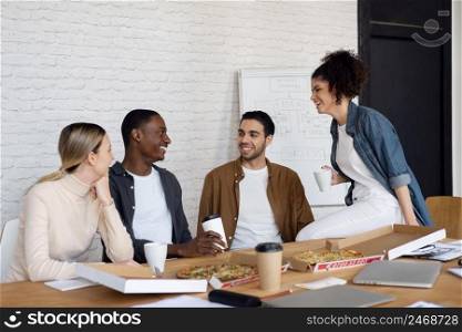 smiley business people with pizza medium shot