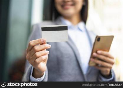 smiley businesswoman with smartphone credit card outdoors. High resolution photo. smiley businesswoman with smartphone credit card outdoors. High quality photo