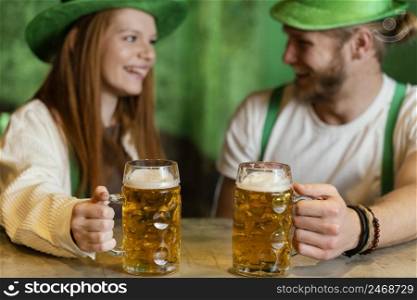 smiley couple celebrating st patrick s day with drinks bar
