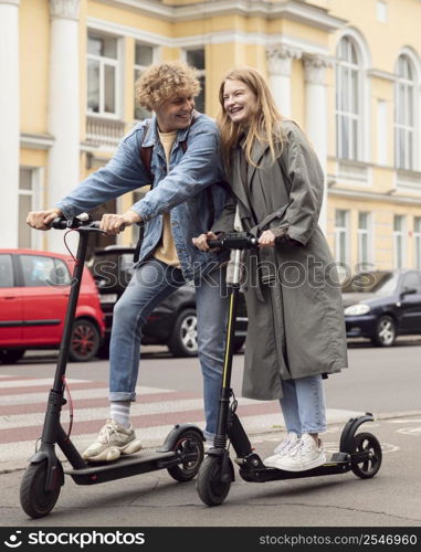 smiley couple posing together outdoors electric scooters