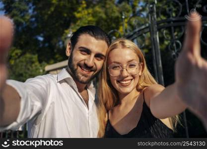 smiley couple taking selfie together