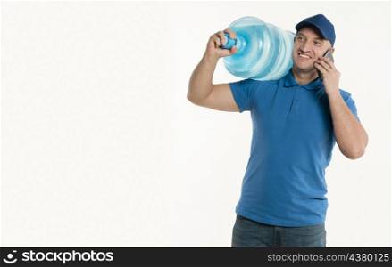 smiley delivery man holding smartphone carrying water bottle