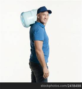 smiley delivery man posing with water bottle