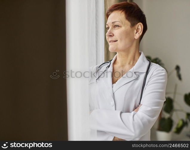 smiley elder covid recovery center female doctor looking through window