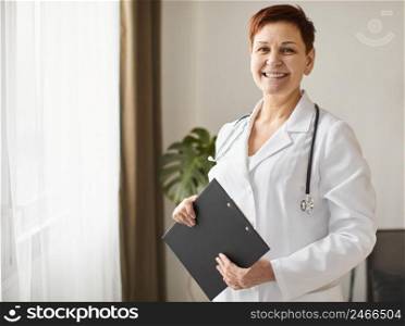 smiley elder covid recovery center female doctor with clipboard stethoscope