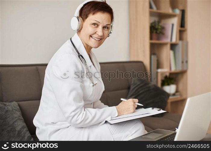 smiley elder covid recovery center female doctor with headphones clipboard