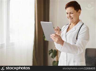 smiley elder covid recovery center female doctor with tablet stethoscope