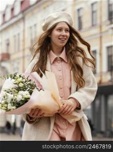 smiley elegant woman outdoors holding bouquet flowers spring