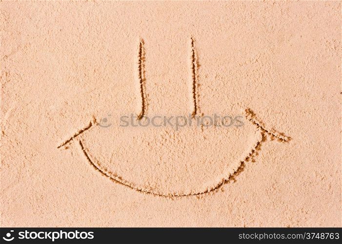 smiley face on the wet sand