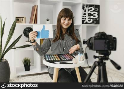 smiley female make up blogger with streaming home with camera