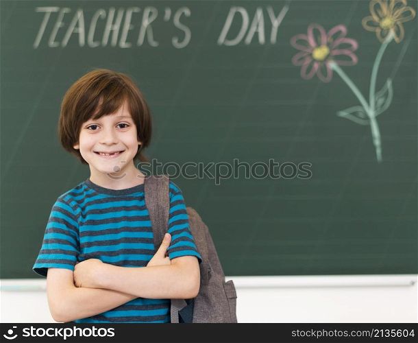 smiley kid posing blackboard
