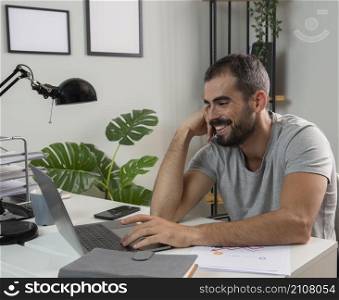 smiley man enjoying working from home