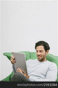 smiley man having fun with tablet