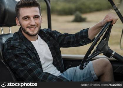 smiley man traveling alone by car