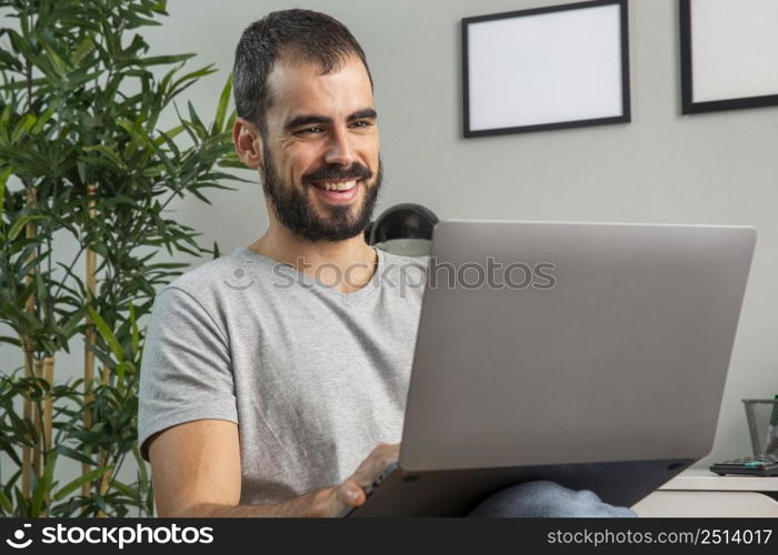 smiley man working from home laptop