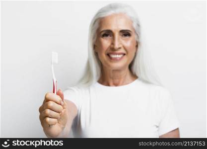 smiley mature woman proud her toothbrush