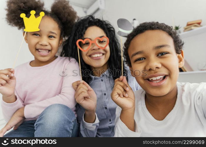 smiley mother taking selfie with her children home