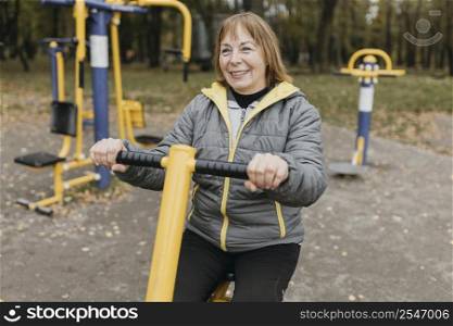 smiley older woman working out outdoors